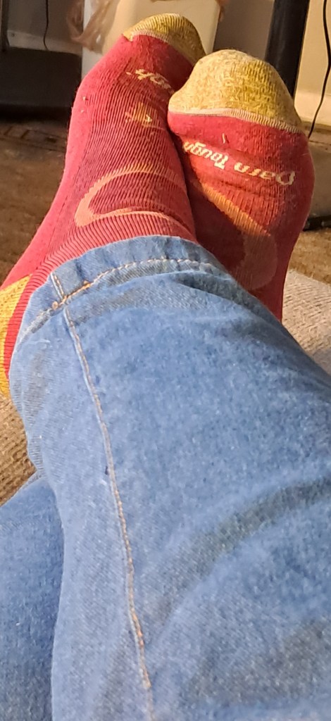 Pair of red and yellow socks, brand name visible. 
