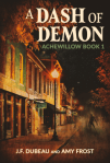 Title Cover: A street at night, lined with shops that seem kind of rustic and small town. There are wrought iron lamp posts along the sidewalk, their orange glow makes the buildings seem blue or green in their light. Title is toward the top, in an all caps decorative font. 